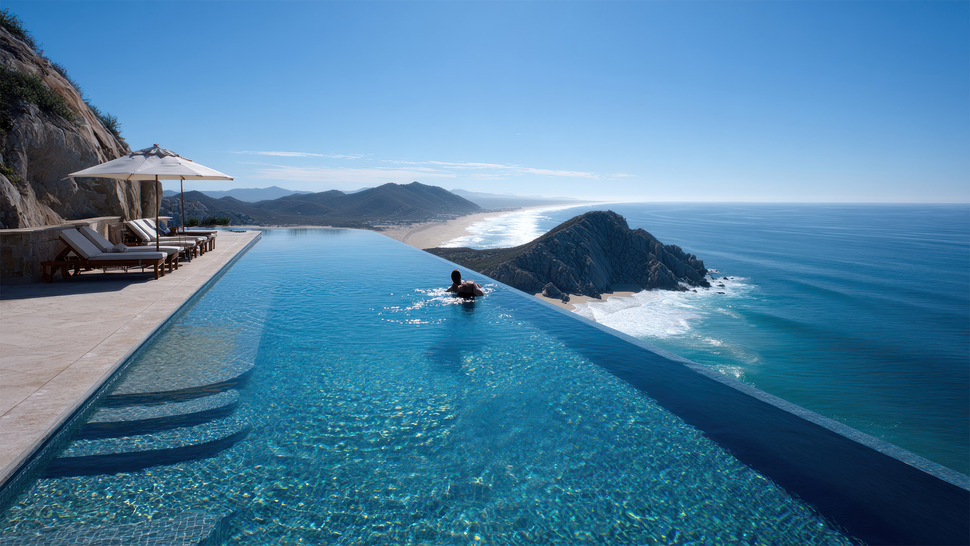 Aerial of Médano Beach and Land’s End with condo buildings in Los Cabos