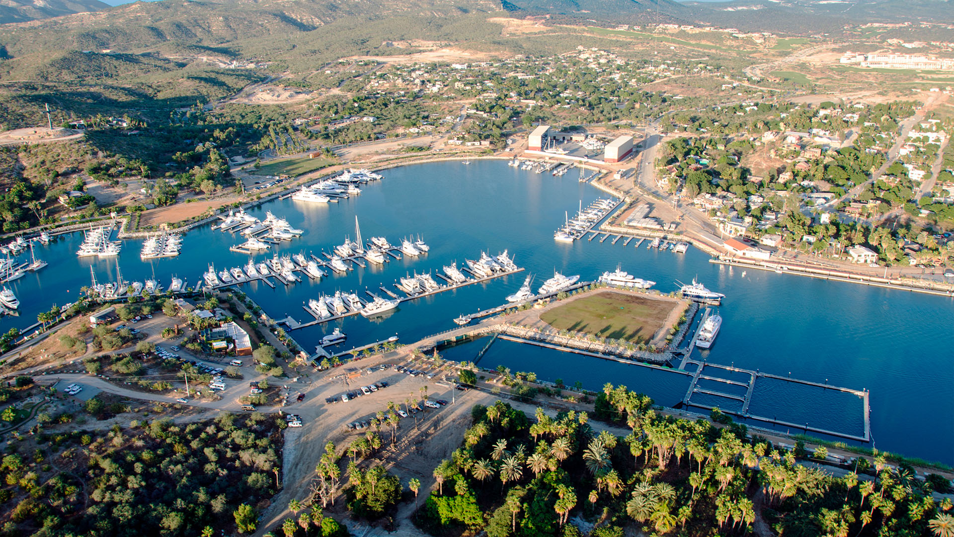 Puerto Los Cabos marina with yachts and desert hills at golden hour