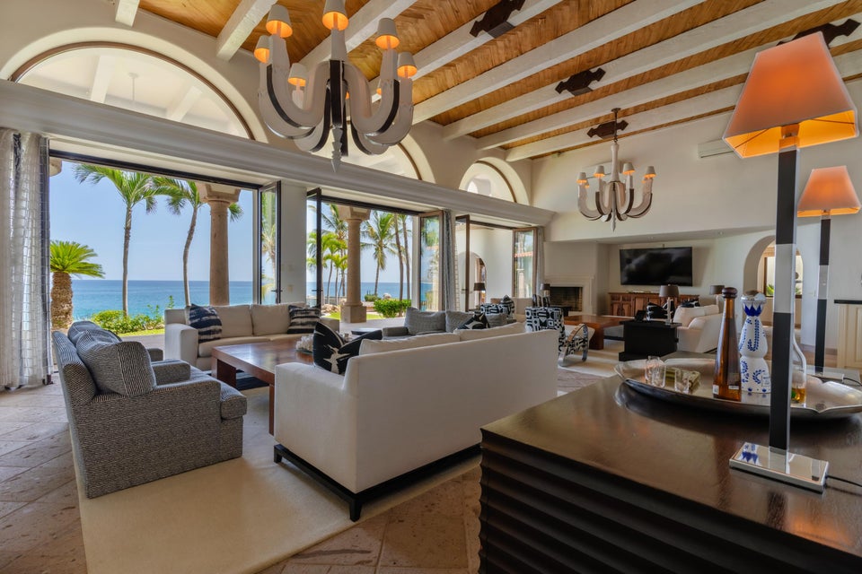 Spacious living room of Palmilla Bay beachfront home with floor-to-ceiling windows overlooking the Sea of Cortez